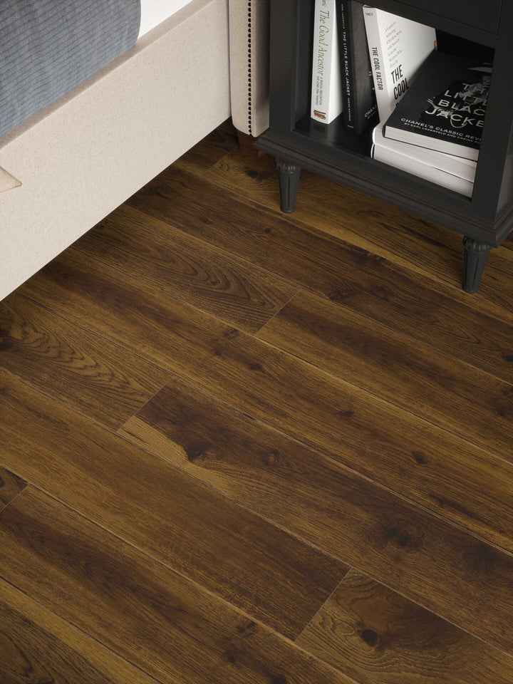 Smoked Cathedral Oak Plank Aqua 72 12mm AC5 Laminate Flooring installed in a bedroom
