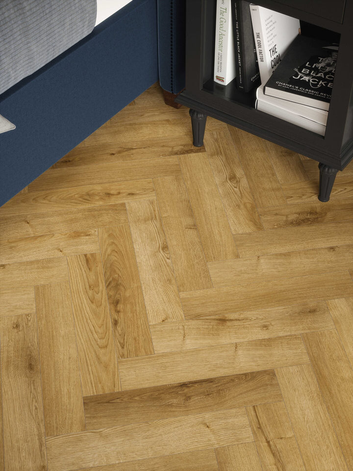Stade Oak 12mm AC4 herringbone laminate flooring installed in a bedroom