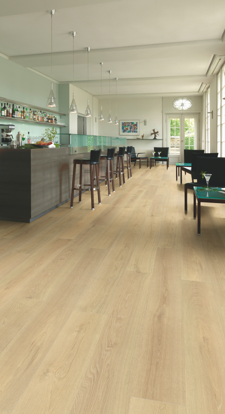 Blonde Montreux Oak Long Plank Aqua Plus 12mm AC5 Laminate Flooring installed in a room